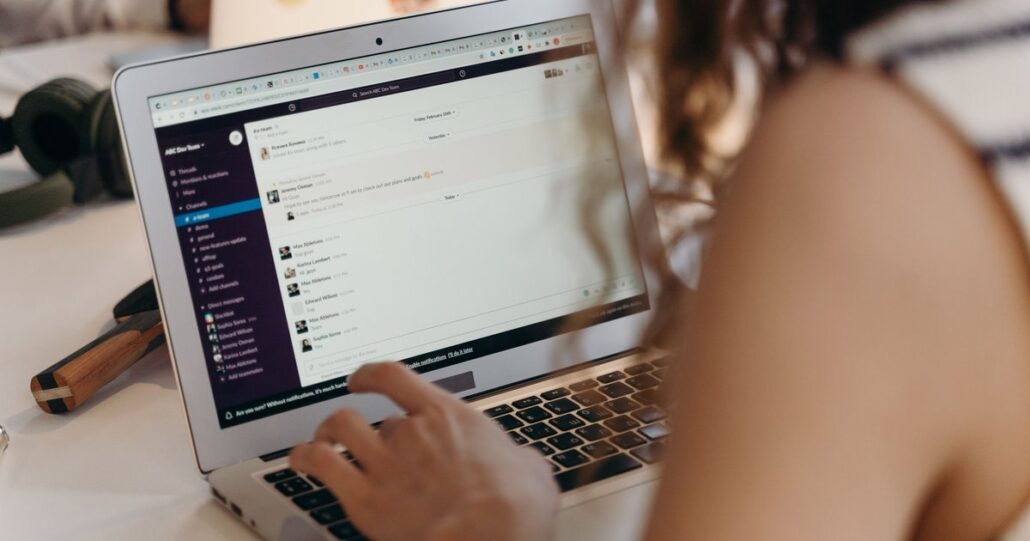 A woman typing on a laptop with an admin screen open